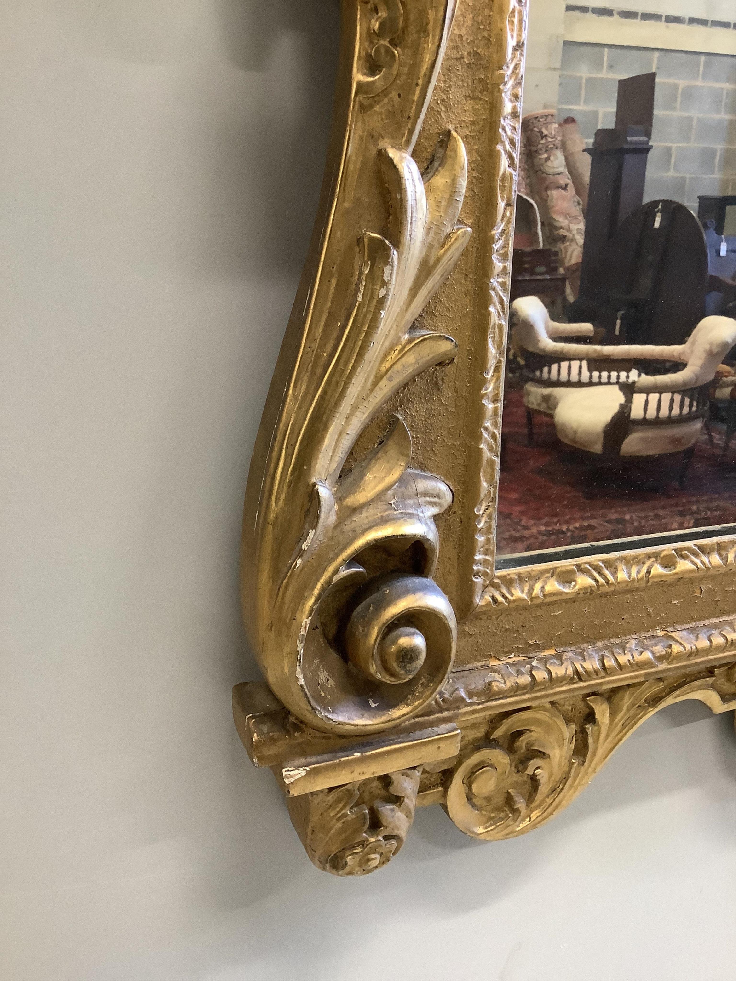 An Adams style giltwood and gesso wall mirror, width 61cm, height 108cm. Condition - fair to good